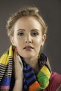 Portrait of beautiful woman holding colorful scarf to her face Royalty Free Stock Photo