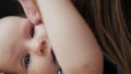 Portrait of a beautiful woman kissing baby, mother kiss her newborn baby close up