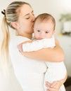 Portrait of beautiful woman kissing her baby boy on hands Royalty Free Stock Photo