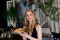 Portrait of beautiful woman in lingerie, black swimsuit with a sweet cake, croissant Royalty Free Stock Photo