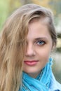 Portrait of beautiful woman with long blonde hairs. Closeup half face.