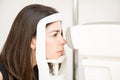 Pretty woman doing eye test in ophthalmology clinic using modern Royalty Free Stock Photo