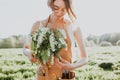 Portrait of beautiful woman making bouquet of wild flowers on flowering field. Summer lifestyle, nature lover and freedom concept Royalty Free Stock Photo