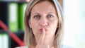 Portrait of beautiful woman making silence gesture with finger Royalty Free Stock Photo