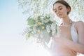 Portrait of beautiful woman making wreath of flowers dandelions on flowering field. Summer lifestyle, nature lover and freedom Royalty Free Stock Photo