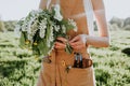 Portrait of beautiful woman making wreath of flowers dandelions on flowering field. Summer lifestyle, nature lover and freedom Royalty Free Stock Photo