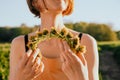 Portrait of beautiful woman making wreath of flowers dandelions on flowering field. Summer lifestyle, nature lover and freedom Royalty Free Stock Photo