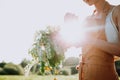 Portrait of beautiful woman making wreath of flowers dandelions on flowering field. Summer lifestyle, nature lover and freedom Royalty Free Stock Photo