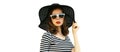 Portrait of beautiful woman model wearing black round summer hat, striped dress isolated on white background Royalty Free Stock Photo