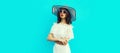 Portrait of beautiful woman model wearing summer straw white hat on blue background Royalty Free Stock Photo