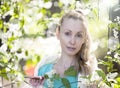 Portrait of the beautiful woman near a white bird cherry Royalty Free Stock Photo