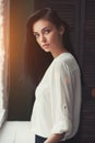 Portrait of a beautiful woman near window