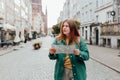 Portrait beautiful woman with paper map on urban street. Young worried female traveler lost in the city using map