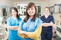 Portrait of beautiful woman patient with dental team in background