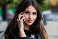 Portrait of a beautiful woman with perfect white smile talking on the mobile phone outdoor Royalty Free Stock Photo