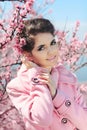 Portrait of Beautiful woman posing over Pink Spring Cherry blossoms. Enjoyment. Royalty Free Stock Photo