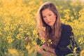 Portrait of beautiful woman in rapeseed field