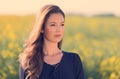 Portrait of beautiful woman in rapeseed field