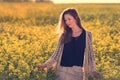 Portrait of beautiful woman in rapeseed field