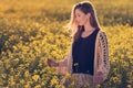 Portrait of beautiful woman in rapeseed field