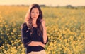 Portrait of beautiful woman in rapeseed field