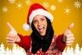 Portrait of beautiful woman in santa hat giving thumbs up Royalty Free Stock Photo