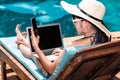 Portrait Beautiful Woman Sitting in deck chair and using laptop Royalty Free Stock Photo