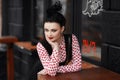 Portrait of a beautiful woman sitting at a table in a street cafe Royalty Free Stock Photo