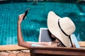 Portrait Beautiful Woman smile Sitting in deck chair and using m Royalty Free Stock Photo