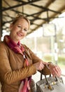 Portrait of a beautiful woman smiling and pointing to her watch Royalty Free Stock Photo