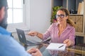 Portrait of beautiful woman smiling and talking to a man next to her talking about business work together in the office. Royalty Free Stock Photo