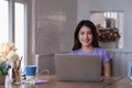 Portrait of beautiful woman and smiling using video call on laptop computer with her parents. Quarantine and work from home Royalty Free Stock Photo