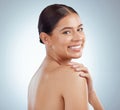 Portrait of beautiful woman with smooth glowing skin and copyspace posing topless and touching shoulder. Smiling Royalty Free Stock Photo