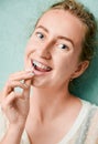 Portrait of woman with braces demonstrating interdental brushing Royalty Free Stock Photo