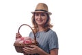 Portrait of beautiful woman with straw hat holding a basket of flowers in hands isolated over white background Royalty Free Stock Photo