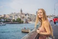 Portrait of beautiful woman tourist with view of Galata tower in Beyoglu, Istanbul, Turkey. Turkiye