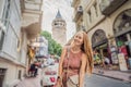 Portrait of beautiful woman tourist with view of Galata tower in Beyoglu, Istanbul, Turkey. Turkiye