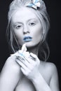 Portrait of a beautiful woman in an unusual winter look with blue lips. Creative make up. Art look.