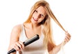 Portrait of beautiful woman using hair straighteners.