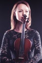 Portrait of beautiful woman with violin