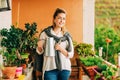 Portrait of beautiful woman watering green plants