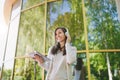 Portrait of beautiful woman wearing light casual clothes. Girl holding tablet pc computer, listening music in headphones Royalty Free Stock Photo