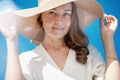 Portrait of beautiful woman wearing straw hat with large brim  looking at camera. Closeup face  smiling girl with freckles and Royalty Free Stock Photo
