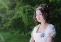 Portrait woman in a white dress with a hairstyle of bride in park Royalty Free Stock Photo