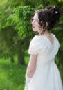 Portrait woman in a white dress with a hairstyle of bride in park Royalty Free Stock Photo