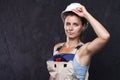 Portrait of beautiful woman worker builder in uniform with white helmet. cute young builder girl in work clothes Royalty Free Stock Photo