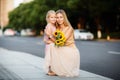 Portrait of beautiful woman and girl with sunflowers