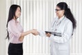 Beautiful woman shaking hands with doctor Royalty Free Stock Photo