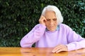 Portrait of a beautiful 90 year old woman. Upset thoughtful mature woman, feeling unwell, lost in thoughts, dementia or Royalty Free Stock Photo