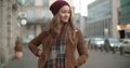 Portrait of beautiful youn woman standing in a city street. Royalty Free Stock Photo